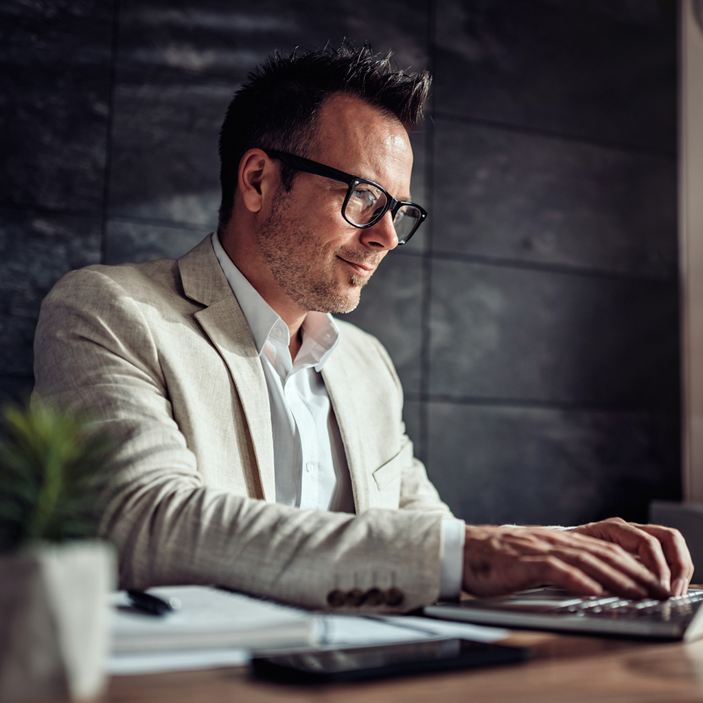 Focused businessman discussing Sukoon's tailored group health insurance plans in a corporate setting